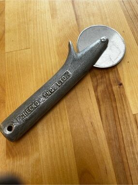 Vintage cast metal pizza cutter by FCHECKO ENG. LTD. Perfect for pizza.